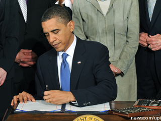 Obama+signing+the+health+care+bill